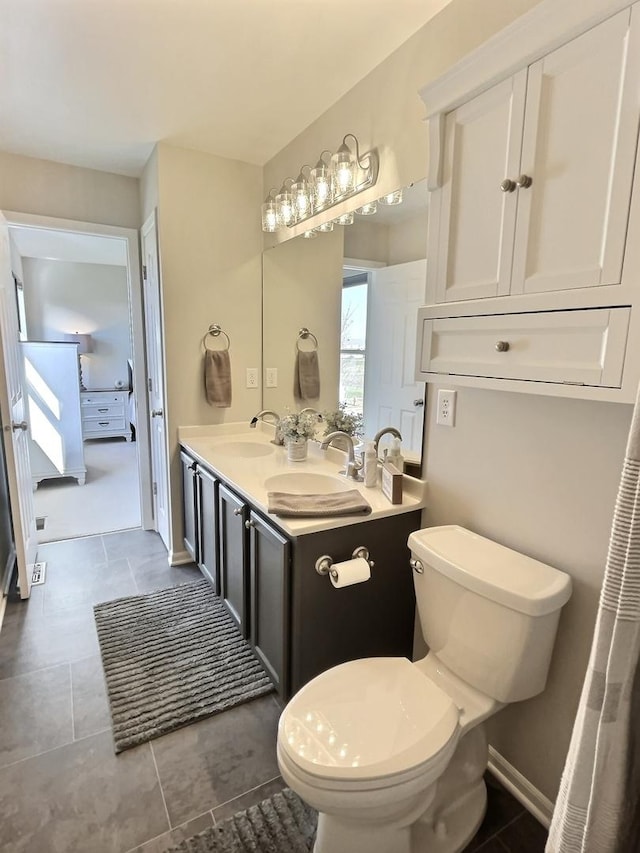 102 W Auburndale Ave, Cortland, IL 60112 - full bath with double vanity, toilet, tile patterned floors, and a sink