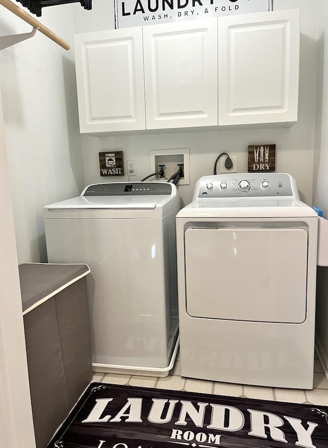 102 W Auburndale Ave, Cortland, IL 60112 - clothes washing area featuring cabinet space, light tile patterned floors, and washer and clothes dryer