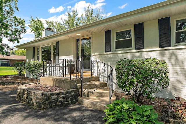15150 109th Ave, Orland Park, IL 60467 - doorway to property with a chimney and covered porch