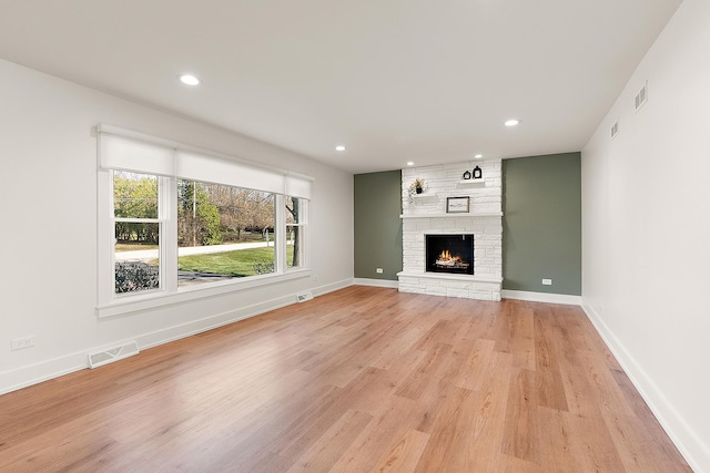 15150 109th Ave, Orland Park, IL 60467 - unfurnished living room with light wood finished floors, recessed lighting, a stone fireplace, and baseboards