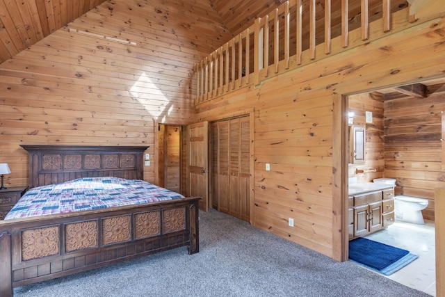carpeted bedroom featuring wooden walls