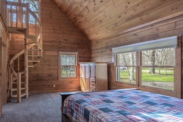 bedroom with lofted ceiling, wooden walls, wooden ceiling, and carpet flooring