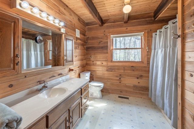 bathroom featuring tile patterned floors, beamed ceiling, wood walls, wooden ceiling, and vanity