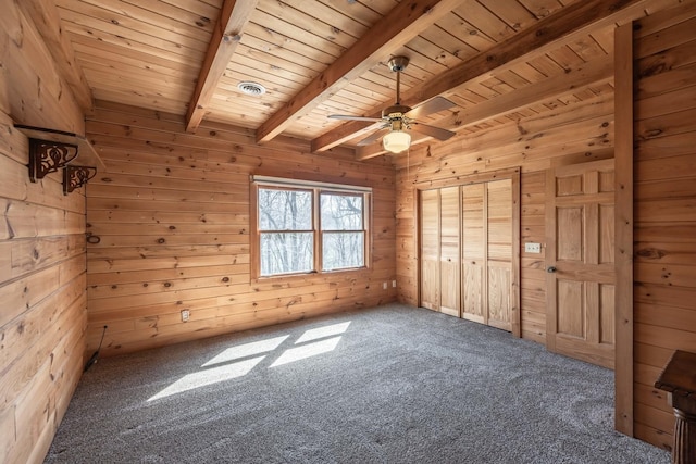 unfurnished bedroom with visible vents, beamed ceiling, wood walls, wood ceiling, and carpet floors