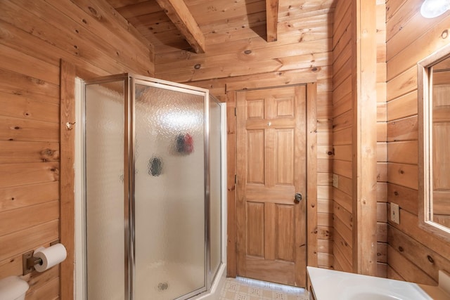 bathroom with wood ceiling, beamed ceiling, wooden walls, and a stall shower