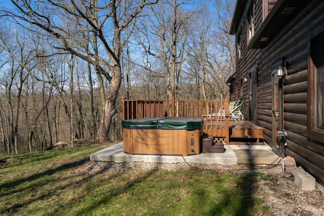 view of yard featuring a hot tub and a deck