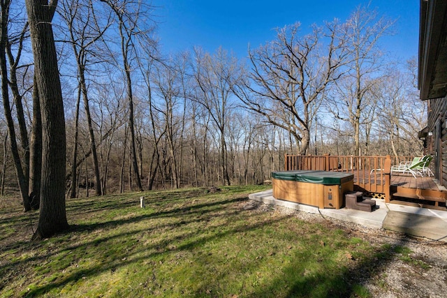view of yard with a wooden deck and a hot tub