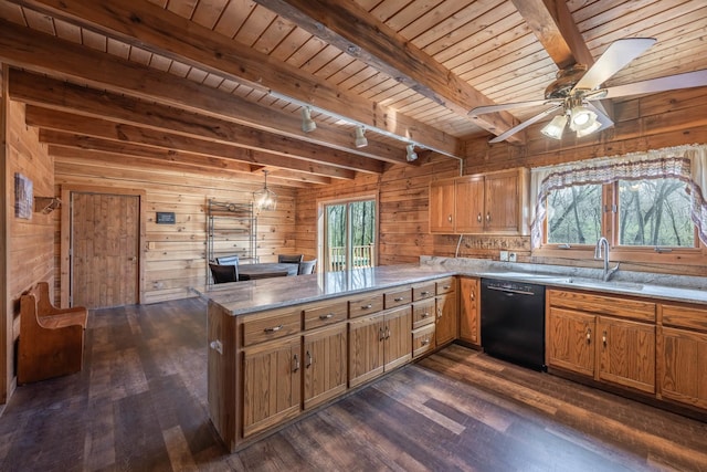 kitchen with beamed ceiling, a sink, dark wood-type flooring, and black dishwasher