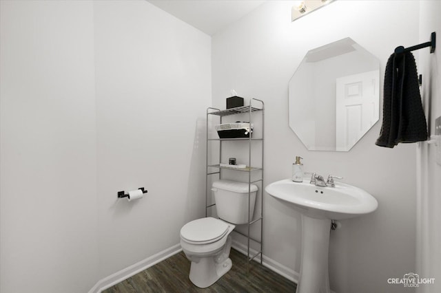 927 Hyte St, Plano, IL 60545 - half bath featuring baseboards, a sink, toilet, and wood finished floors