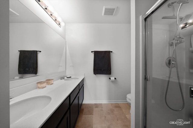 927 Hyte St, Plano, IL 60545 - bathroom with a sink, visible vents, a shower stall, and double vanity