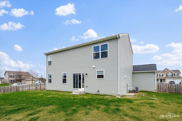 927 Hyte St, Plano, IL 60545 - back of property with fence, a lawn, and central air condition unit