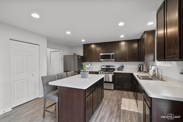 927 Hyte St, Plano, IL 60545 - kitchen featuring a sink, light countertops, dark brown cabinets, stainless steel appliances, and a breakfast bar area