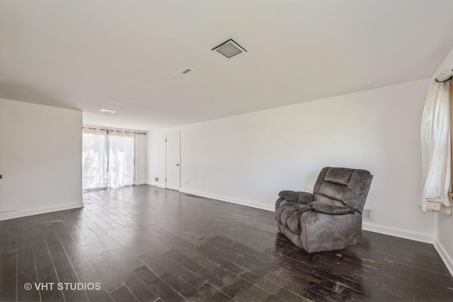 unfurnished room featuring dark wood-style floors and baseboards