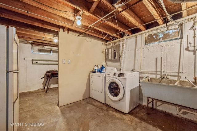 washroom featuring independent washer and dryer and electric panel