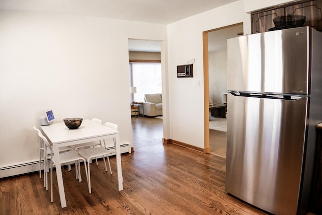 dining room with baseboards and wood finished floors