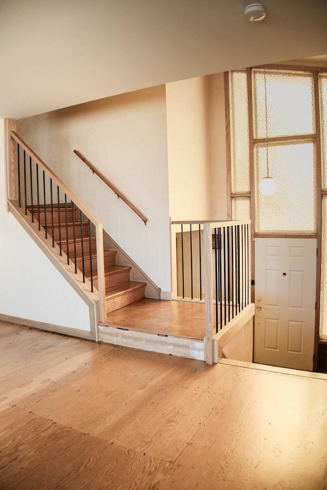 stairway featuring wood finished floors