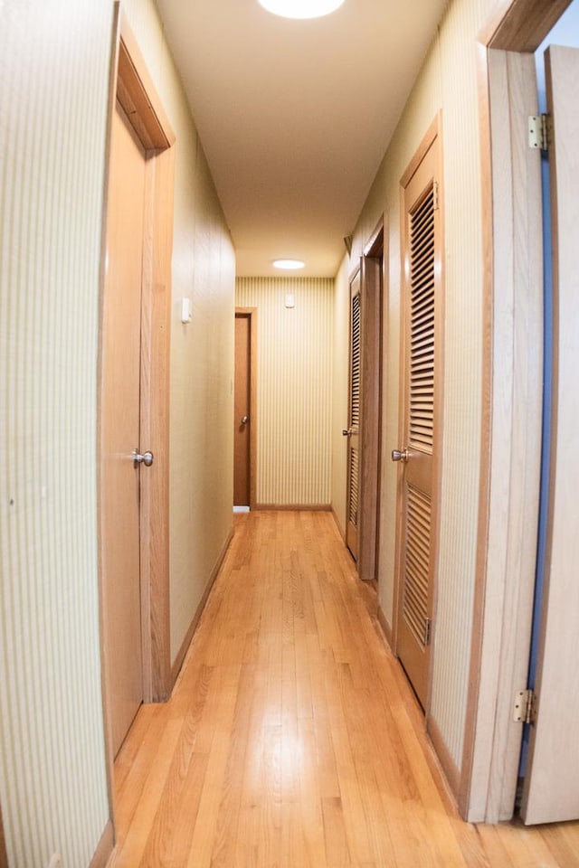 hallway with light wood-style floors