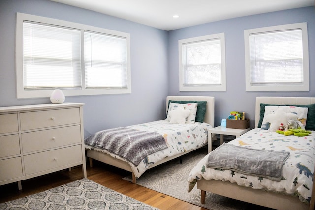 bedroom with wood finished floors and recessed lighting