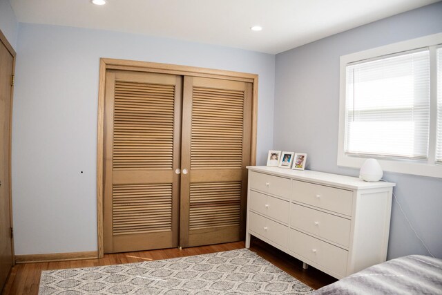 bedroom with recessed lighting, baseboards, a closet, and wood finished floors
