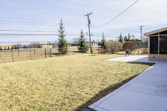 view of yard featuring a sunroom, fence, and a patio area