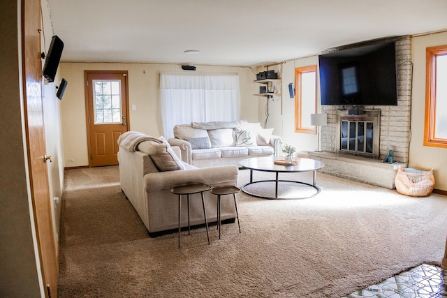 carpeted living area featuring baseboards and a fireplace