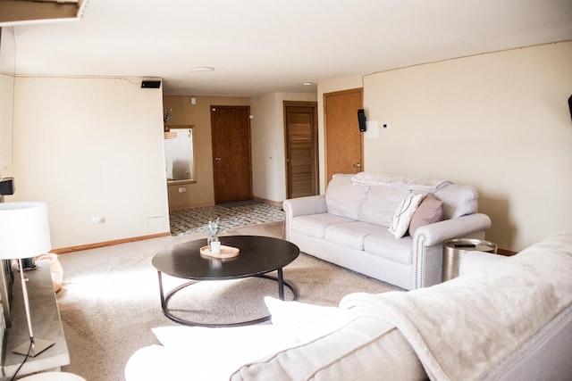 carpeted living room featuring baseboards
