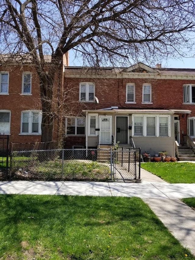 10505 S Corliss Ave, Chicago, IL 60628 - view of property with a front yard, a fenced front yard, and brick siding