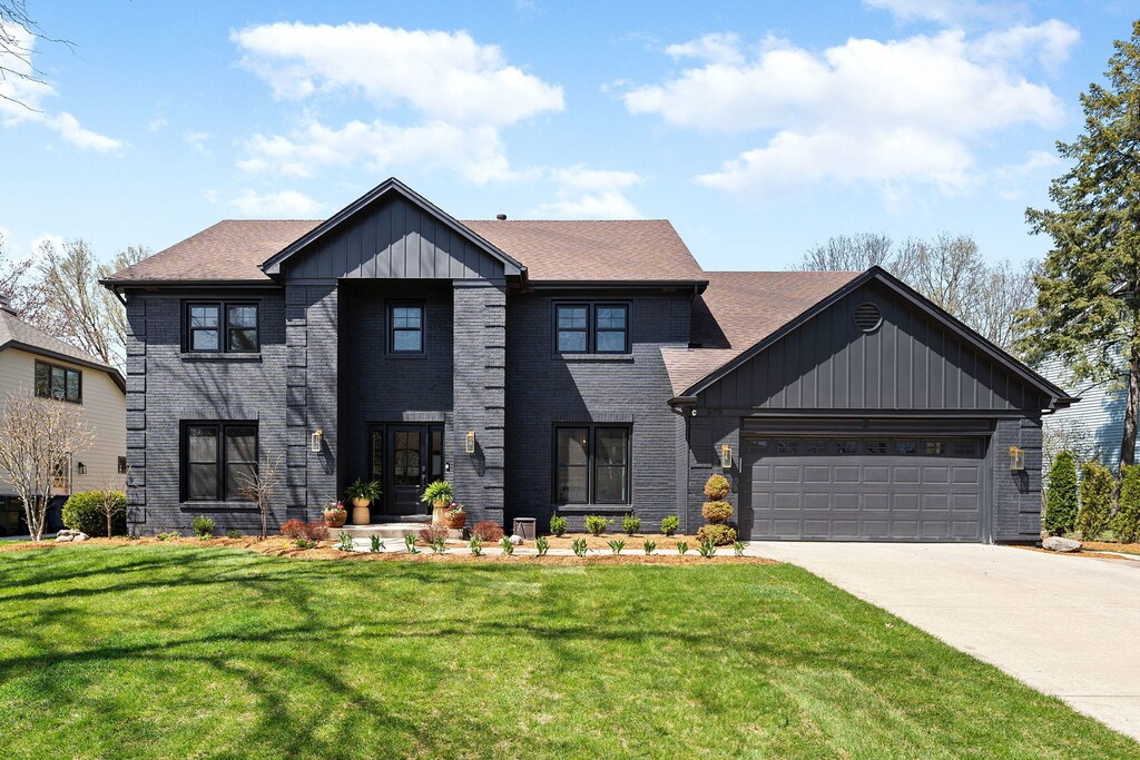 675 Cavalcade Cir, Naperville, IL 60540 - view of front of house with a garage, driveway, a front yard, brick siding, and roof with shingles