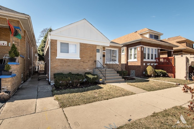bungalow-style house featuring board and batten siding and brick siding
