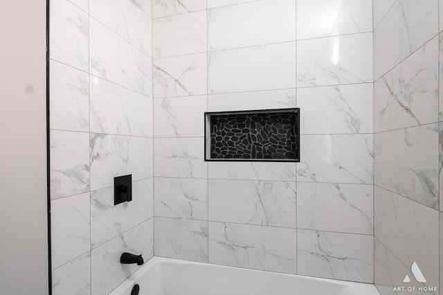 bathroom with bathing tub / shower combination