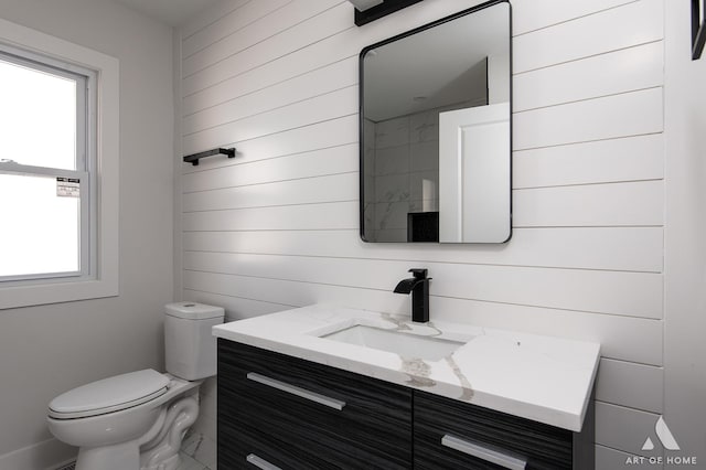half bathroom with toilet and vanity