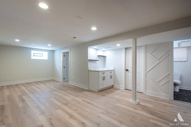 basement featuring recessed lighting, baseboards, visible vents, and light wood-type flooring
