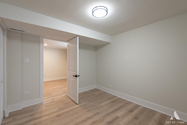 interior space with baseboards, visible vents, and light wood-type flooring
