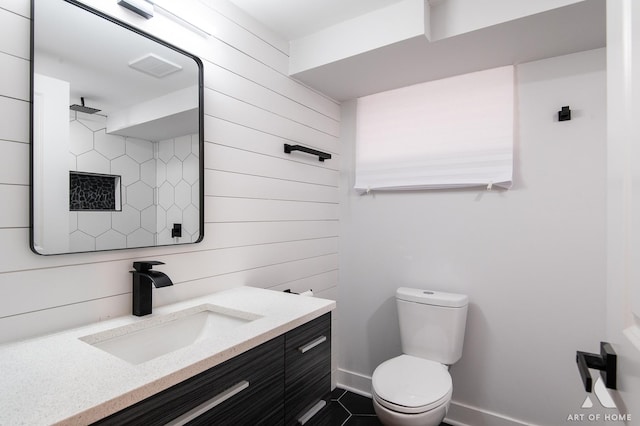 bathroom featuring vanity, toilet, baseboards, tile patterned floors, and visible vents