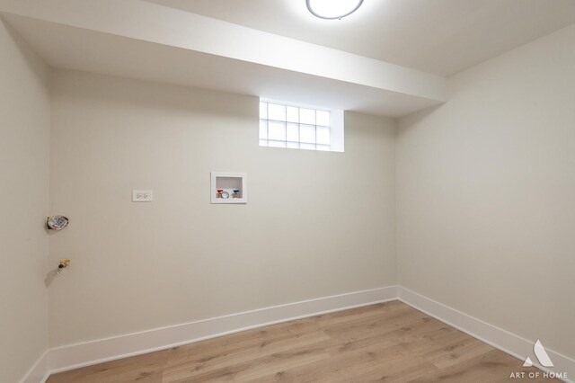 laundry room featuring baseboards, washer hookup, light wood-style flooring, and laundry area