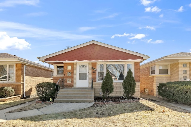 bungalow-style house featuring brick siding