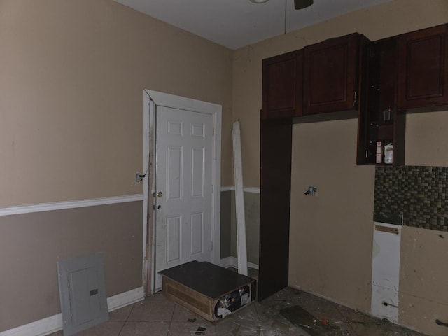 kitchen featuring dark brown cabinets, a ceiling fan, and light tile patterned flooring