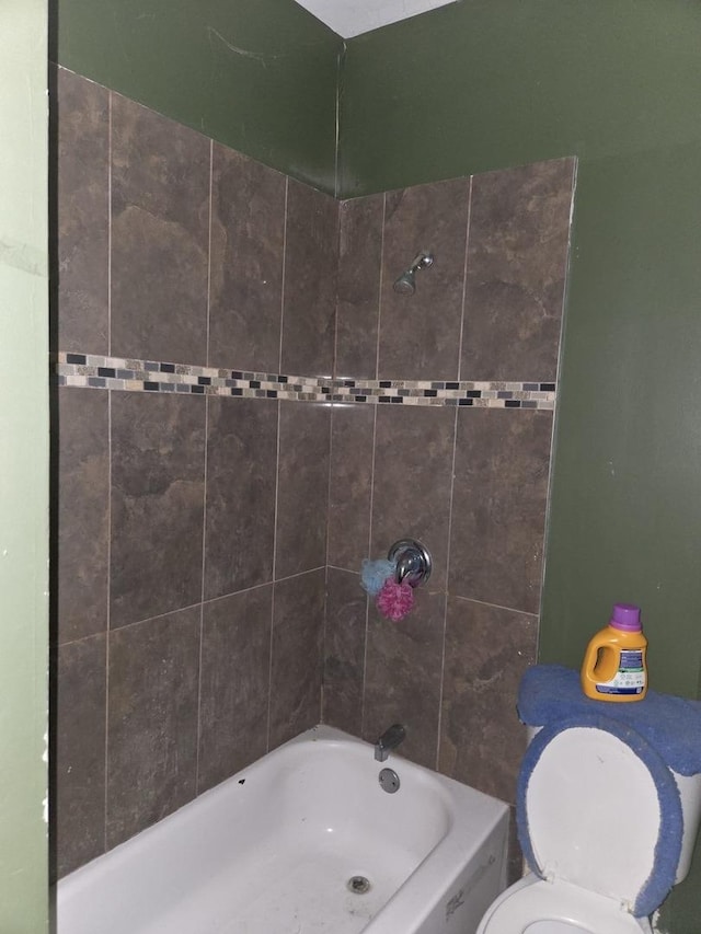 bathroom with tub / shower combination and toilet