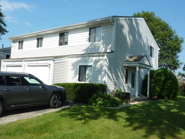 275 London Pl Unit 275, Wheeling, IL 60090 - view of front of house with driveway, an attached garage, and a front yard