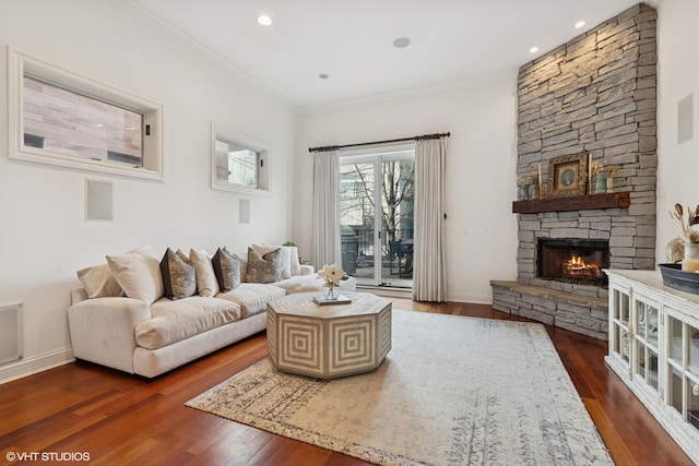 living room featuring a fireplace, dark wood finished floors, baseboards, and ornamental molding