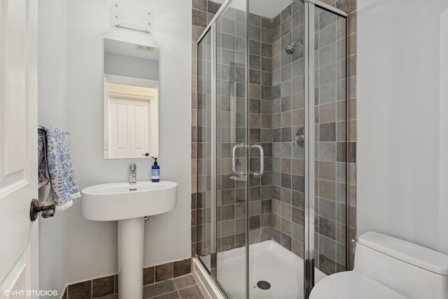 full bath with a shower stall and toilet