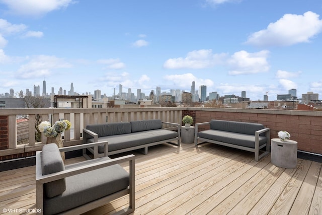 wooden terrace featuring outdoor lounge area and a view of city