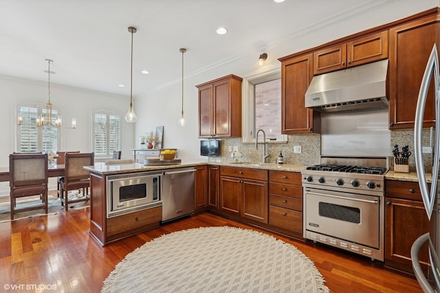kitchen featuring decorative backsplash, stainless steel appliances, under cabinet range hood, and a sink