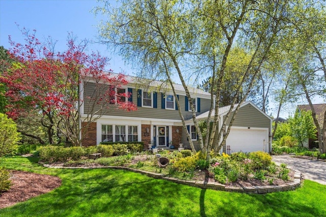 401 Aurora Ct, Vernon Hills, IL 60061 - colonial house featuring a garage, a front yard, brick siding, and driveway