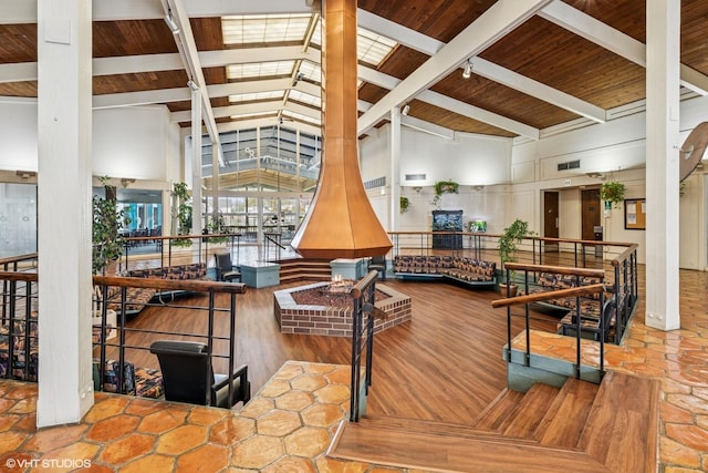 community lobby featuring beam ceiling, high vaulted ceiling, and wooden ceiling