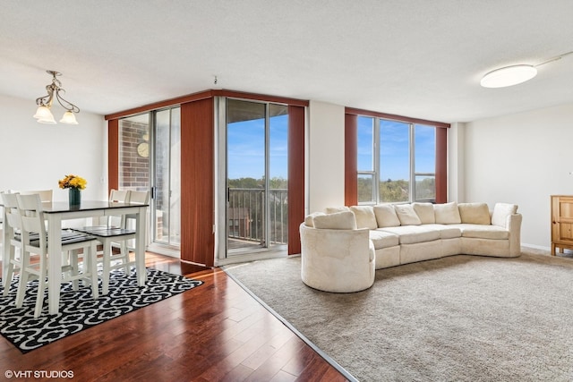 living area featuring a wall of windows and wood finished floors