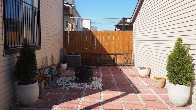 3005 N Kostner Ave, Chicago, IL 60641 - view of patio with central AC unit, a fire pit, and fence