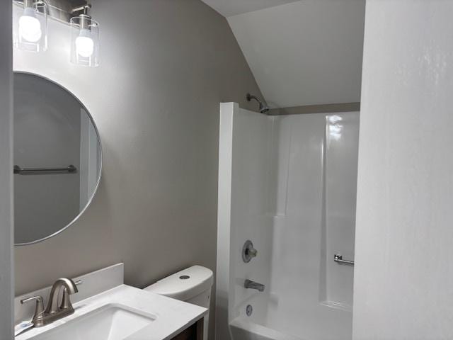 638 Virgil Ave, Elgin, IL 60120 - bathroom featuring vanity, shower / bathing tub combination, vaulted ceiling, and toilet