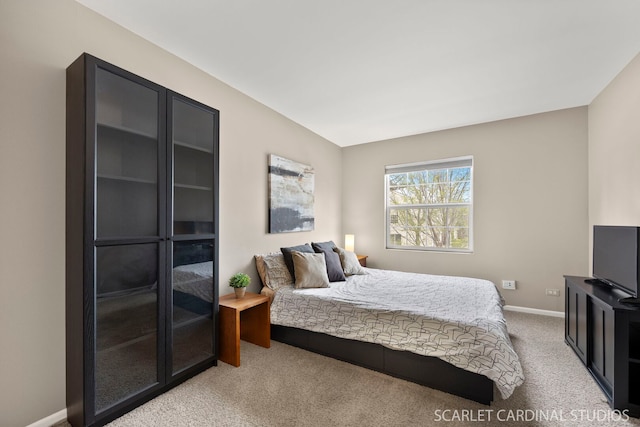 bedroom with light carpet and baseboards