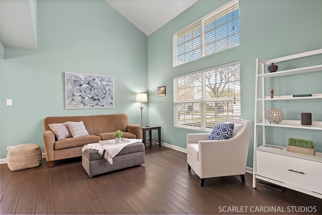 living room with baseboards, wood finished floors, and high vaulted ceiling